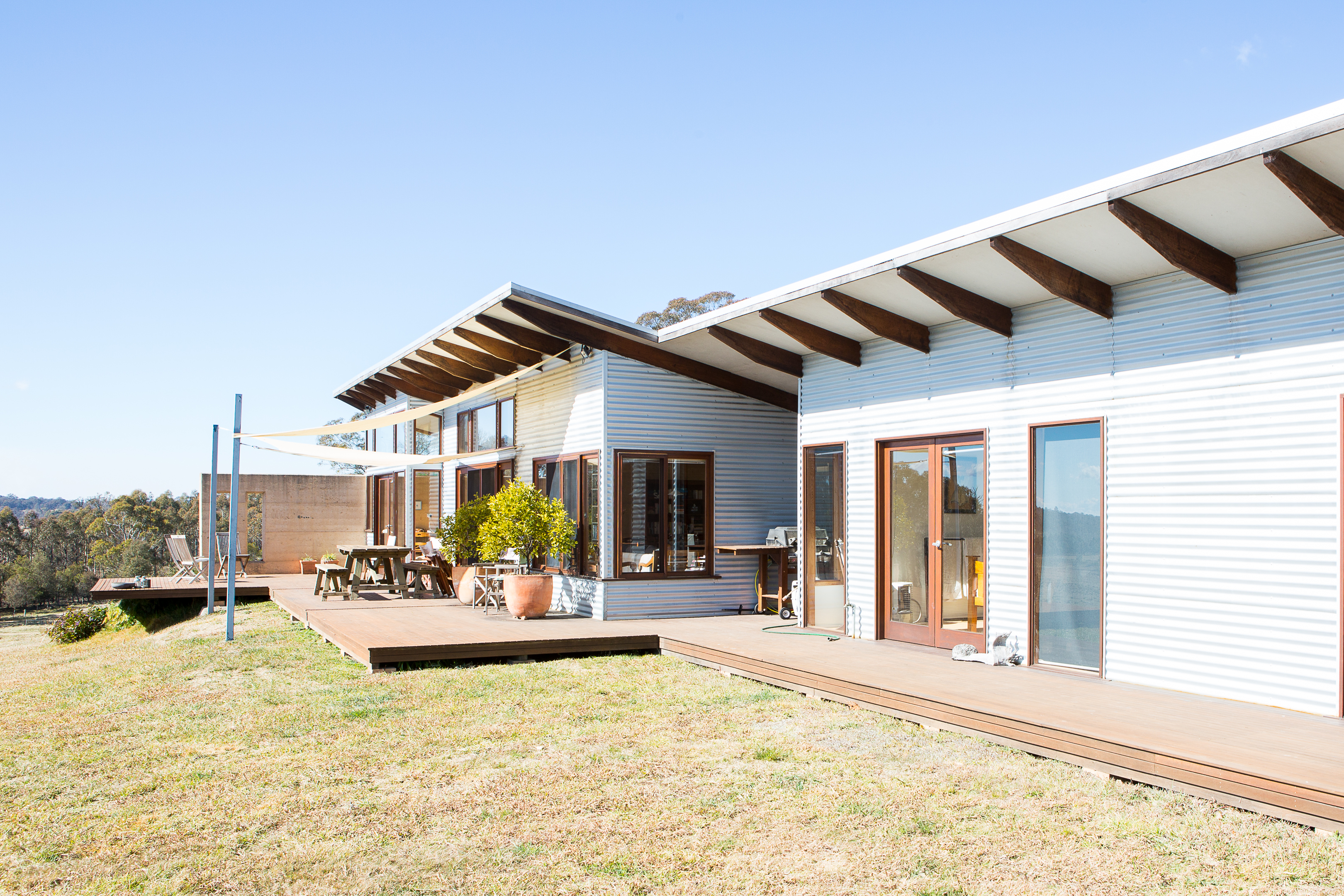Rammed Earth and Corrugated Iron Home featuring Moar Windows & Doors
