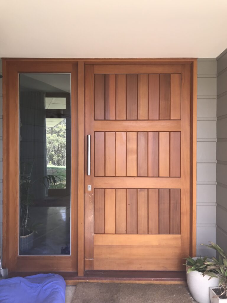 vertical tongue and groove panelled entrance door with sidelight